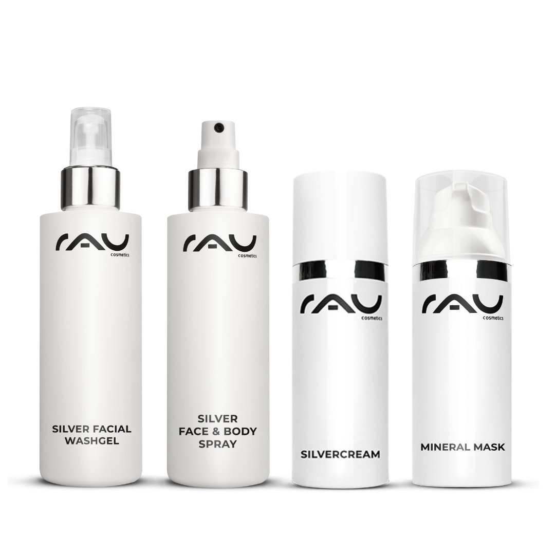 Professional skincare routine for neurodermatitis by RAU Cosmetics, consisting of Silver Wash Gel, Silver Face & Body Spray, Silver Cream, and Mineral Mask, in elegant white bottles with a black logo.